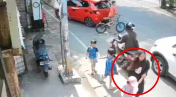 Seorang perempuan berambut pirang (dilingkari merah) terlihat menggandeng seorang anak kecil, diduga Balita Bilqis (4), saat terekam CCTV di Jalan Pettarani, Makassar.