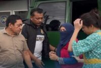 Petugas Kejari Gowa menggiring Kepsek SMPN 1 Pallangga (berjilbab dan mengenakan masker) saat tiba di Rutan Kelas I Makassar untuk menjalani penahanan terkait korupsi Dana BOS senilai Rp 1,37 miliar.