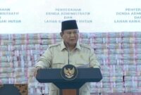 Presiden Prabowo Subianto berdiri di depan tumpukan uang hasil sitaan negara. (Ist)