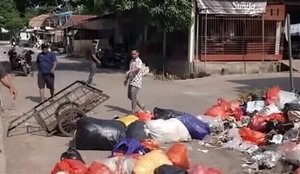 Tangkapan layar video saat warga menutup sebagian badan jalan dengan tumpukan sampah di sekitar Pasar Enrekang sebagai aksi protes atas keterlambatan pengangkutan sampah.